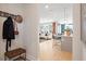 View of an entryway with coat hooks and a bench, looking toward the living room and kitchen at 3249 Shirecrest Ln, Dacula, GA 30019