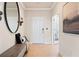 Bright entryway with wood-look floors, a bench, and a large circular mirror at 3249 Shirecrest Ln, Dacula, GA 30019