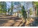 Private backyard with mature trees and a partially fenced yard at 3578 Adkins Nw Rd, Atlanta, GA 30331
