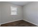 Spacious bedroom featuring hardwood floors and a window with blinds at 3578 Adkins Nw Rd, Atlanta, GA 30331