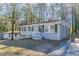 Gray brick ranch house with a driveway and mature trees at 3578 Adkins Nw Rd, Atlanta, GA 30331