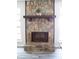 Stone fireplace with a dark brown mantel and hearth at 3742 Tree Bark Ln, Snellville, GA 30039