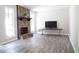 Living room with stone fireplace and hardwood floors at 3742 Tree Bark Ln, Snellville, GA 30039