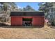 Large red barn with open doors and an American flag at 5275 Johnson Spur, Loganville, GA 30052