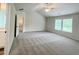 Main bedroom with tray ceiling, ceiling fan and access to bathroom at 67 Longhorn Way, Auburn, GA 30011