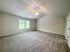 Large bedroom with tray ceiling, ceiling fan, and two windows at 67 Longhorn Way, Auburn, GA 30011