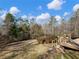 Landscaped backyard with deck and distant pool view at 2402 Highway 138 Sw, Conyers, GA 30094