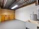 Unfinished basement with utility sink and hot water heater at 2402 Highway 138 Sw, Conyers, GA 30094