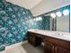 Bathroom with double vanity and floral wallpaper at 2402 Highway 138 Sw, Conyers, GA 30094