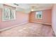 Spacious bedroom with ceiling fan and large windows at 2402 Highway 138 Sw, Conyers, GA 30094