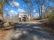 Long driveway leading to a charming Tudor-style home at 2402 Highway 138 Sw, Conyers, GA 30094