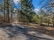Long driveway into a wooded area with split path at 2402 Highway 138 Sw, Conyers, GA 30094