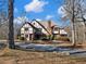 Two-story house with a Tudor style exterior, nestled among tall trees at 2402 Highway 138 Sw, Conyers, GA 30094