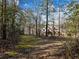 Tudor style home viewed from across a wooded yard at 2402 Highway 138 Sw, Conyers, GA 30094