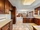 Kitchen with dark wood cabinets and tiled floor at 2402 Highway 138 Sw, Conyers, GA 30094