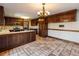 Kitchen with island, dark wood cabinets, and tiled floor at 2402 Highway 138 Sw, Conyers, GA 30094