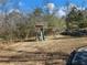 Wooden playset with slide in a backyard setting at 2402 Highway 138 Sw, Conyers, GA 30094