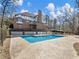 Large inground pool with brick coping and home view at 2402 Highway 138 Sw, Conyers, GA 30094