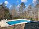 Inviting swimming pool with lounge chairs and wooded backdrop at 2402 Highway 138 Sw, Conyers, GA 30094