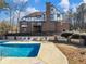 Large in-ground pool and patio area, with home in background at 2402 Highway 138 Sw, Conyers, GA 30094