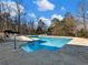 Sparkling pool with lounge chairs, surrounded by trees at 2402 Highway 138 Sw, Conyers, GA 30094