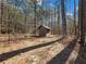 Small wooden shed nestled in a wooded setting at 2402 Highway 138 Sw, Conyers, GA 30094