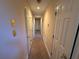 Long hallway with carpeted floors and multiple doors at 4342 White Surrey Nw Dr, Kennesaw, GA 30144