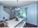 Dining area with hardwood floors, white table, and blue walls; view of entryway at 8140 Highland Dr, Covington, GA 30014