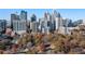 Picturesque aerial view of the city skyline with lush trees in the foreground at 1058 Piedmont Ne Ave # 302, Atlanta, GA 30309
