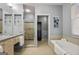 Well-lit bathroom featuring a double sink vanity, a glass enclosed shower, and a soaking tub at 1058 Piedmont Ne Ave # 302, Atlanta, GA 30309