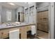 Sleek bathroom featuring dual sinks, a large mirror, glass shower and gray color scheme at 1058 Piedmont Ne Ave # 302, Atlanta, GA 30309