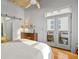 Bedroom with hardwood floors, balcony access, and sliding barn door at 1058 Piedmont Ne Ave # 302, Atlanta, GA 30309