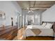 Sunlit bedroom showcasing a cozy bed, a vintage ceiling fan and access to a private balcony at 1058 Piedmont Ne Ave # 302, Atlanta, GA 30309