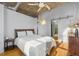 Bright bedroom featuring hardwood floors, modern ceiling fan, and a sliding door to the ensuite bathroom at 1058 Piedmont Ne Ave # 302, Atlanta, GA 30309