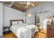Spacious bedroom featuring hardwood floors, neutral walls, and a sliding door leading to the bathroom at 1058 Piedmont Ne Ave # 302, Atlanta, GA 30309