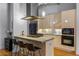 Modern kitchen with light wood cabinets, stainless steel appliances, and breakfast bar at 1058 Piedmont Ne Ave # 302, Atlanta, GA 30309
