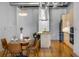 Open concept kitchen with stainless appliances and hardwood floors next to a cozy dining area at 1058 Piedmont Ne Ave # 302, Atlanta, GA 30309