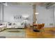 Bright living room featuring a comfortable sofa, a dining table with modern chairs, and hardwood floors at 1058 Piedmont Ne Ave # 302, Atlanta, GA 30309