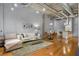 Open living area with hardwood floors, exposed ductwork, and modern furniture at 1058 Piedmont Ne Ave # 302, Atlanta, GA 30309