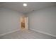 Spacious bedroom with gray walls, carpet flooring, and access to a hallway at 131 Wards Crossing Way # 19, Johns Creek, GA 30022