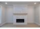 Modern living room features a white stacked stone fireplace with a light brown mantel at 131 Wards Crossing Way # 19, Johns Creek, GA 30022