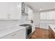 Modern kitchen with white cabinets, stainless steel appliances, and quartz countertops at 131 Wards Crossing Way # 19, Johns Creek, GA 30022