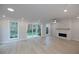 Spacious living area with hardwood floors, fireplace, and sliding glass doors to backyard at 131 Wards Crossing Way # 19, Johns Creek, GA 30022