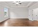 Bright main bedroom with hardwood floors, ceiling fan and window seat at 131 Wards Crossing Way # 19, Johns Creek, GA 30022