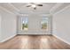 Spacious main bedroom with hardwood floors, tray ceiling, and ceiling fan at 131 Wards Crossing Way # 19, Johns Creek, GA 30022