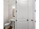 Small half bathroom with pedestal sink, toilet, and hardwood floors at 131 Wards Crossing Way # 19, Johns Creek, GA 30022