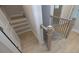 Modern staircase with light wood steps and dark metal railing at 131 Wards Crossing Way # 19, Johns Creek, GA 30022