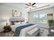 Main bedroom with a king-size bed and ceiling fan at 7788 Richmond Trl, Fairburn, GA 30213