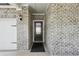 Front entrance with a dark gray door and brick facade at 7788 Richmond Trl, Fairburn, GA 30213