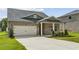 Brick house with a two-car garage and a covered porch at 7788 Richmond Trl, Fairburn, GA 30213